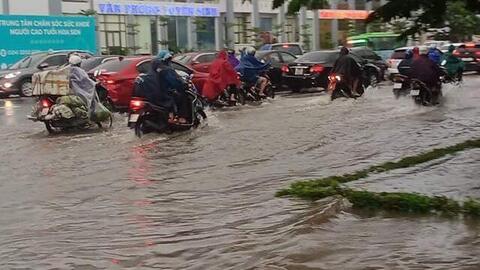 Mưa lớn kéo dài cả đêm, người dân Hà Nội đi làm trong "biển nước"