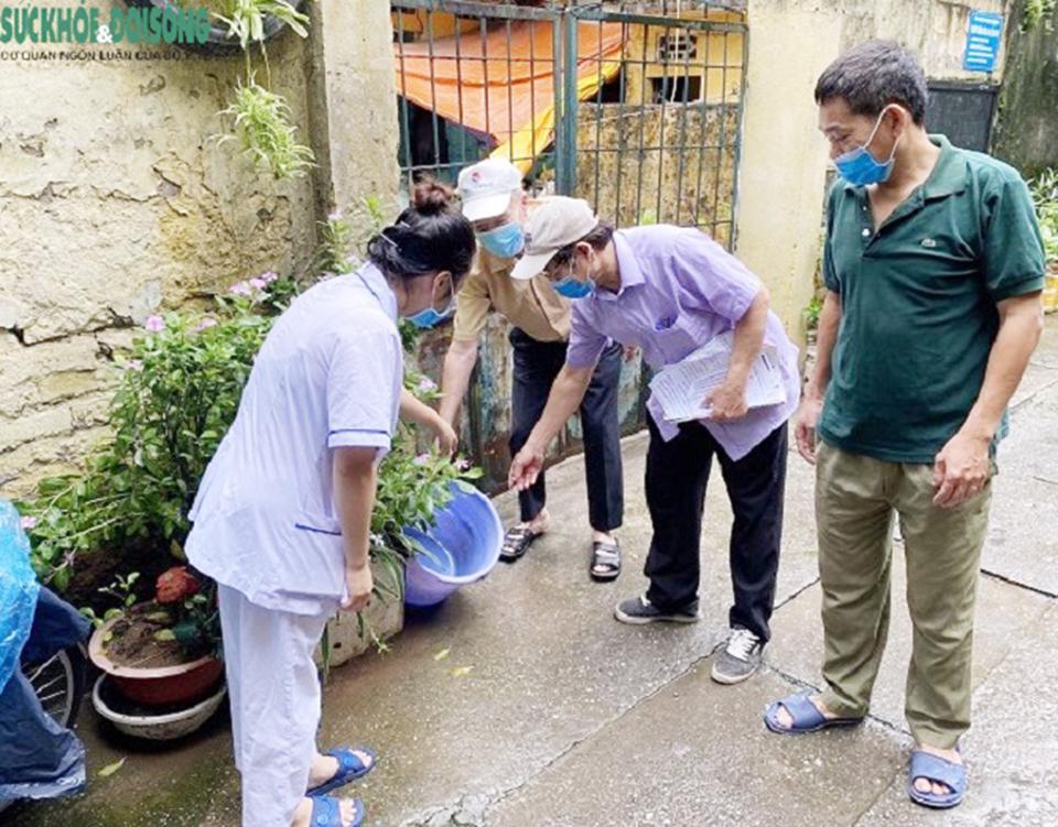 Nh&acirc;n vi&ecirc;n y tế cơ sở hướng dẫn người d&acirc;n loại bỏ c&aacute;c dụng cụ chứa nước c&oacute; bọ gậy để ph&ograve;ng bệnh sốt xuất huyết.