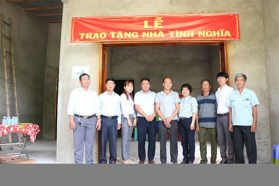 Đại diện Vietcombank Tiền Giang (thứ 4 từ trái sang) cùng chính quyền địa phương chụp hình lưu niệm với ông Nguyễn Văn Vũ tại căn nhà vừa được bàn giao