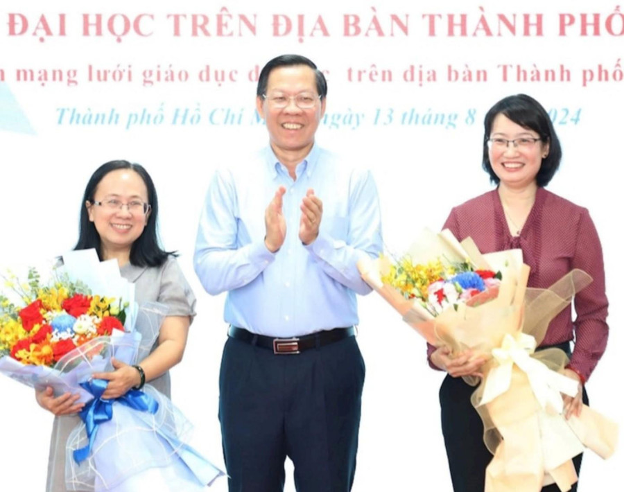 Chủ tịch UBND TPHCM Phan Văn Mãi trao hoa chúc mừng bà Trần Thị Diệu Thúy (bên phải) và bà Đinh Thị Thanh Thủy. Ảnh: T.Thuyền