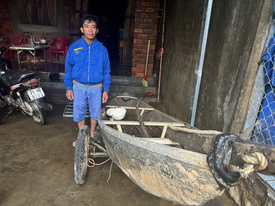 Anh Trần Công Thành bên chiếc ghe nhỏ đã cứu 40 người trong lũ dữ ở xã Hòa Thịnh, Đắk Lắk. (Ảnh: TT)